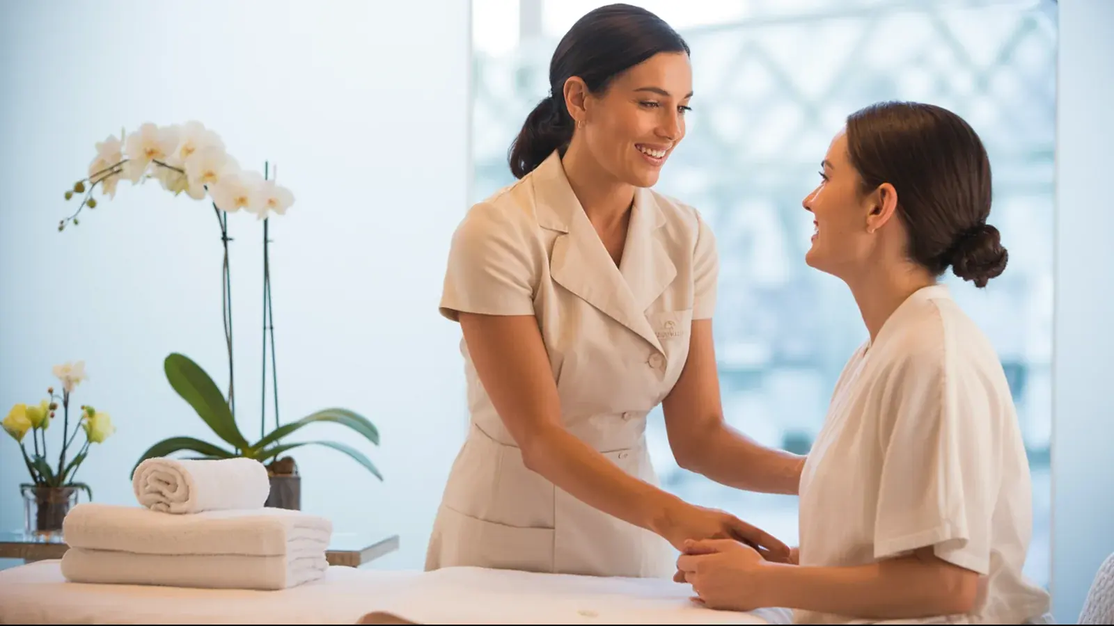 The owner of a day spa at work with a customer, in a bright real moment