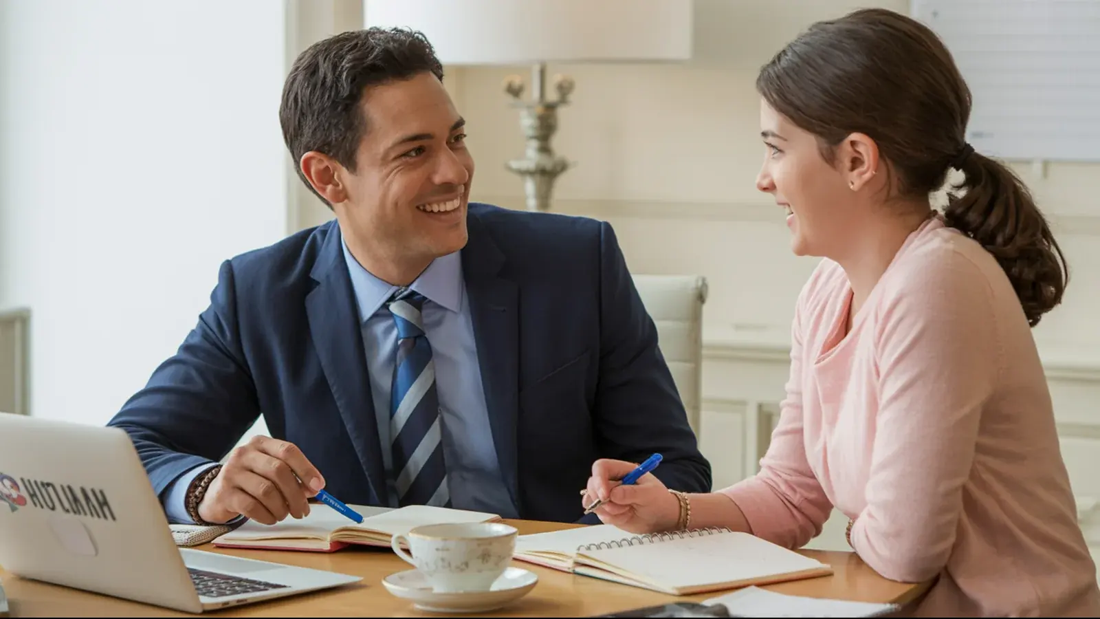 The owner of a tutoring business at work with a customer, in a bright real moment
